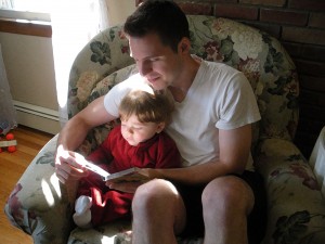 Father reads with son...